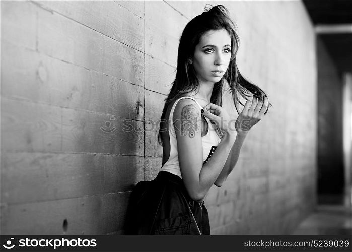 Portrait of beautiful young woman in urban background