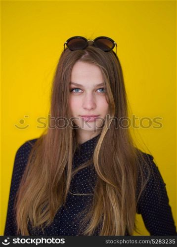 portrait of Beautiful young woman isolated on yellow background