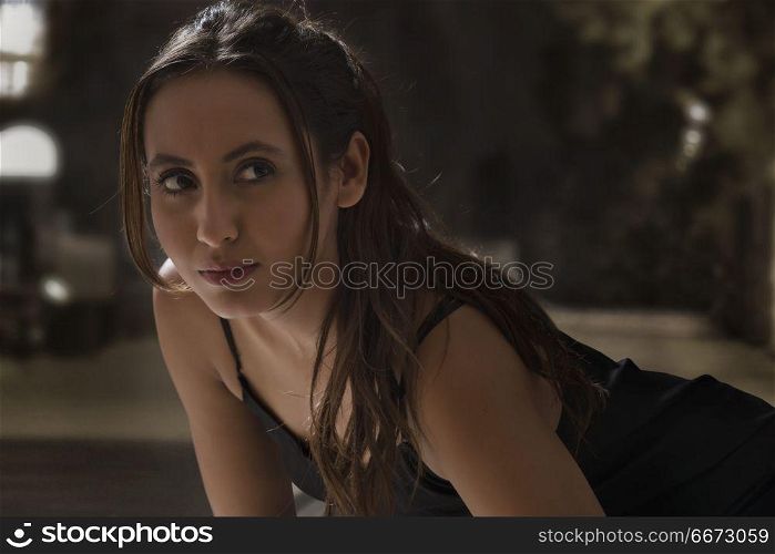 Portrait of beautiful young woman jogger on road at night