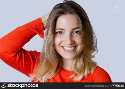 Portrait of beautiful young woman, looking at camera in a studio.