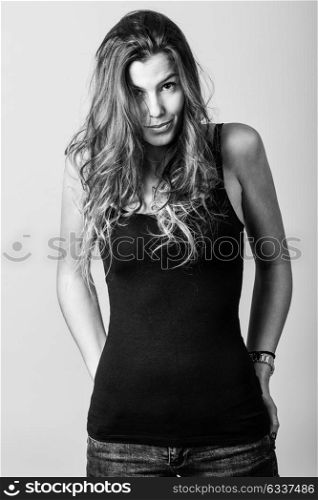 Portrait of beautiful young woman, model of fashion, wearing casual clothes. Studio shot