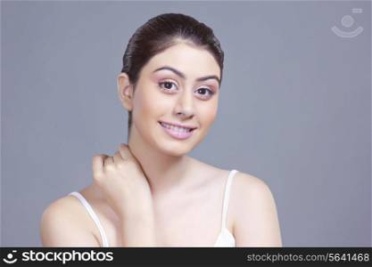 Portrait of beautiful young woman over blue background