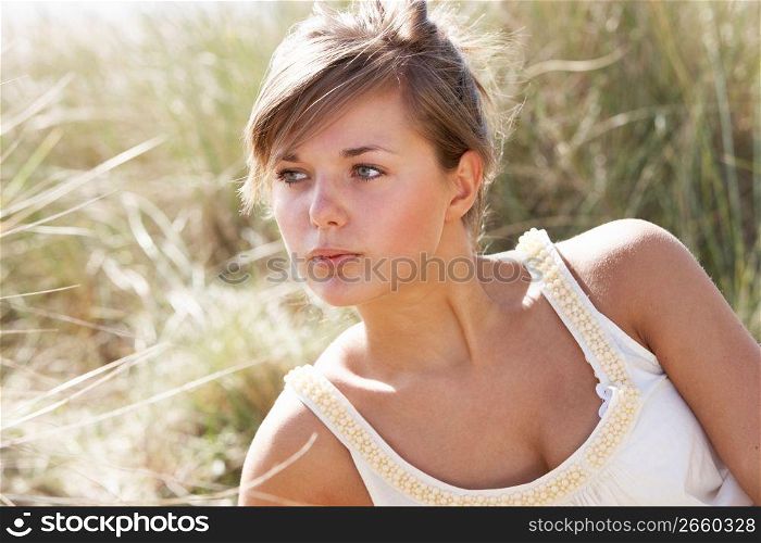 Portrait Of Beautiful Young Woman Relaxing On Beach
