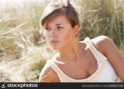 Portrait Of Beautiful Young Woman Relaxing On Beach