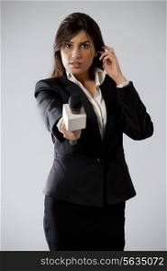 Portrait of beautiful young woman reporter listening through earphone