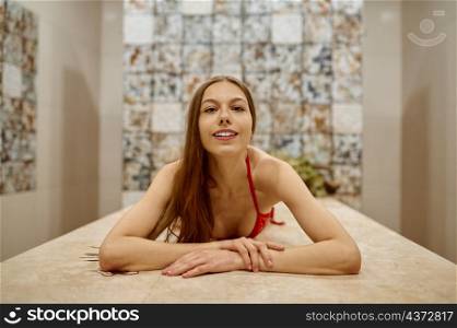 Portrait of beautiful young woman resting in sauna and taking care of her skin. Spa and hygiene. Beautiful woman resting in sauna enjoy spa