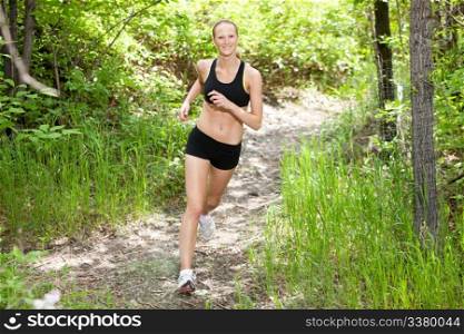 Portrait of beautiful young woman running in the forest