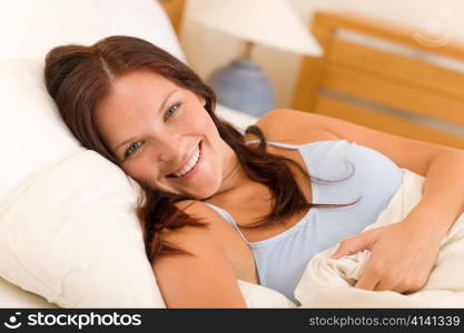 Portrait of beautiful young woman sleeping in white bed