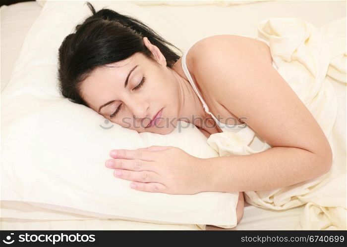 Portrait of beautiful young woman sleeping on the bed.