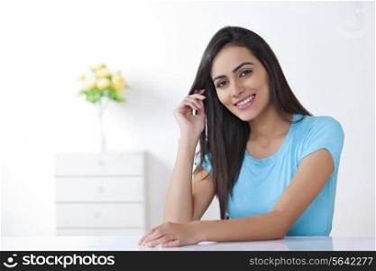 Portrait of beautiful young woman smiling at home