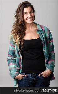 Portrait of beautiful young woman smiling, model of fashion, wearing casual clothes. Studio shot