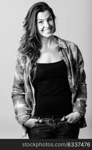 Portrait of beautiful young woman smiling, model of fashion, wearing casual clothes. Studio shot