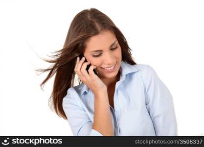 Portrait of beautiful young woman talking on mobilephone