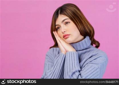 Portrait of beautiful young woman thinking about new idea and looking at something isolated over pink background. People lifestyle concept.