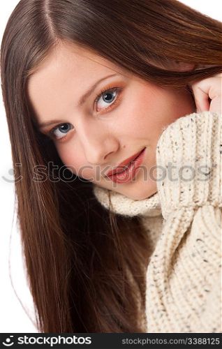 Portrait of beautiful young woman wearing turtleneck on white background