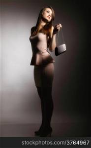 Portrait of beautiful young woman with a handbag. Fashion photo