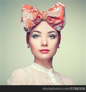 Portrait of beautiful young woman with bow. Brunette girl. Beauty fashion. Cosmetic make-up