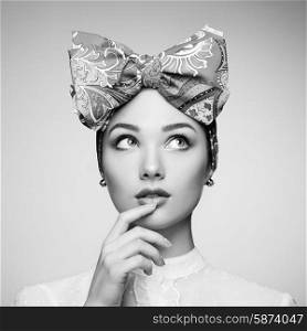 Portrait of beautiful young woman with bow. Brunette girl. Beauty fashion. Cosmetic make-up. Black and white