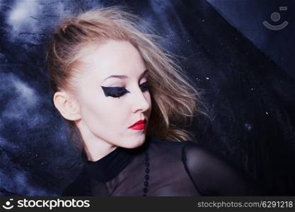 Portrait of beautiful young woman with bright gothic makeup
