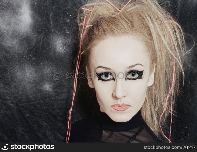 Portrait of beautiful young woman with bright gothic makeup closeup