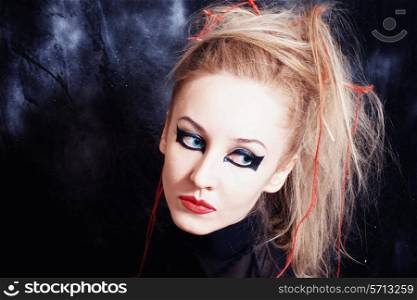 Portrait of beautiful young woman with bright gothic makeup closeup