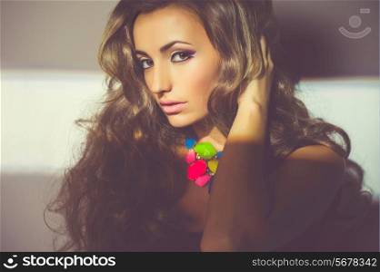 Portrait of beautiful young woman with bright necklace