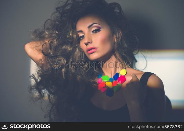 Portrait of beautiful young woman with bright necklace