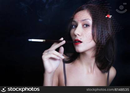 Portrait of beautiful young woman with cigarettel. Japanese style