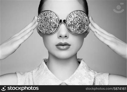 Portrait of beautiful young woman with colored glasses. Beauty fashion. Perfect make-up. Colorful decoration. Jewelry. Black and white