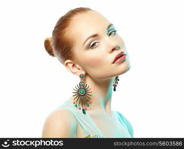 Portrait of beautiful young woman with earring. Fashion photo