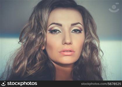Portrait of beautiful young woman with evening make up