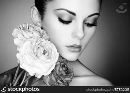 Portrait of beautiful young woman with flowers. Perfect makeup. Perfect skin. Fashion photo. Black and white