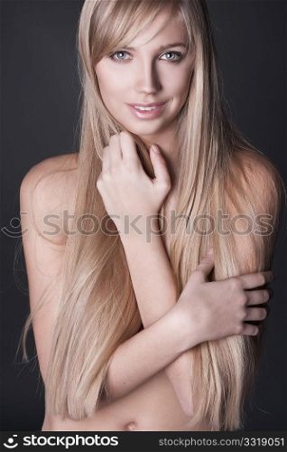 portrait of beautiful young woman with long straight blond hair