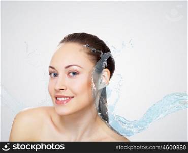 Portrait of beautiful young woman with water splashes