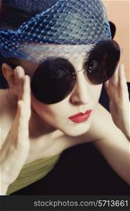 Portrait of beautiful young women in veils and round sunglasses