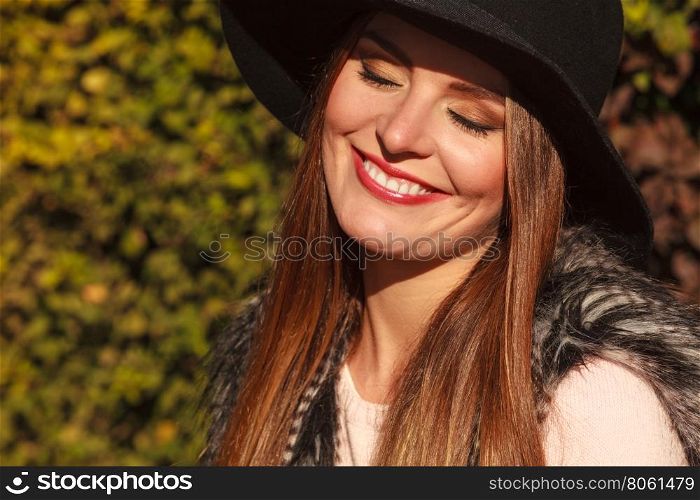 Portrait of beauty woman in hat. Gorgeous stylish young woman wearing fashionable clothes. Portrait of girl in black hat outside.
