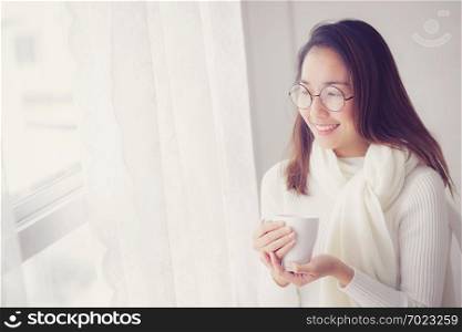 Portrait of bedroom concept  asian woman holding a cup of coffee with on bedroom in breakfast time.