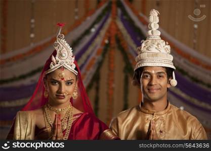Portrait of Bengali bride and groom greeting