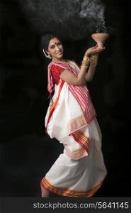 Portrait of Bengali woman doing dhunuchi dance