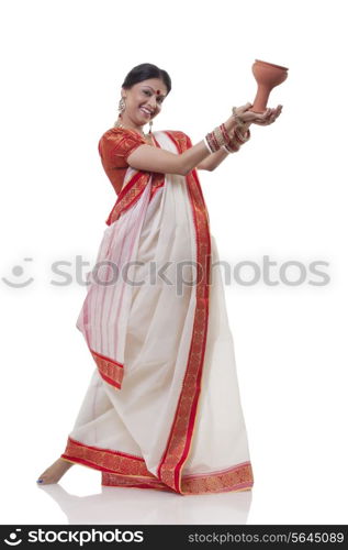 Portrait of Bengali woman doing Dhunuchi dance