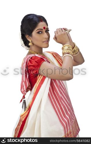 Portrait of Bengali woman holding a conch shell