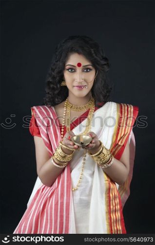 Portrait of Bengali woman holding a diya