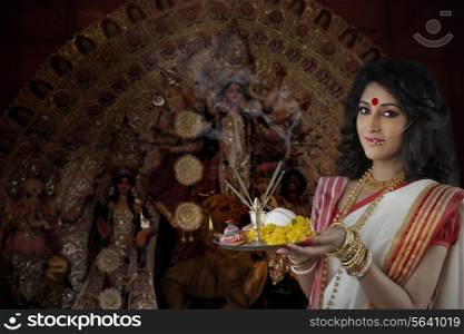 Portrait of Bengali woman holding a puja thali