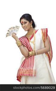 Portrait of Bengali woman holding currency