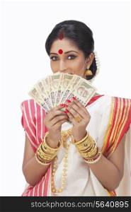 Portrait of Bengali woman holding currency notes