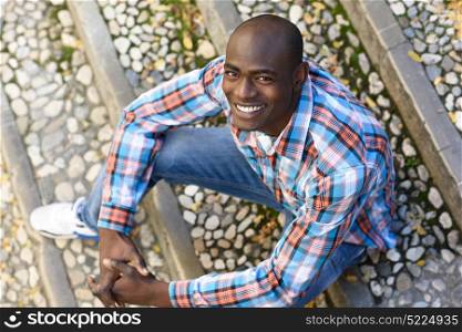 Portrait of black man very happy, smiling in urban background