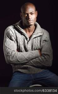 Portrait of black man wearing casual clothes in black background
