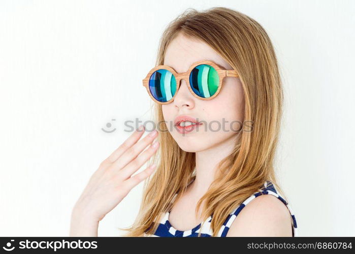 Portrait of blond girl in green sunglasses on white