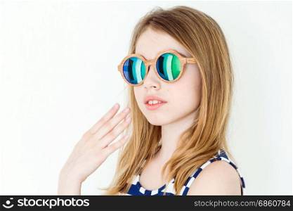 Portrait of blond girl in green sunglasses on white