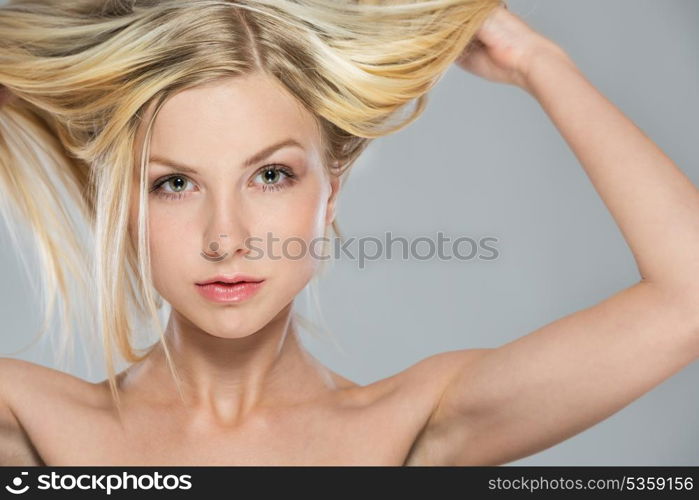 Portrait of blond girl rising up hair